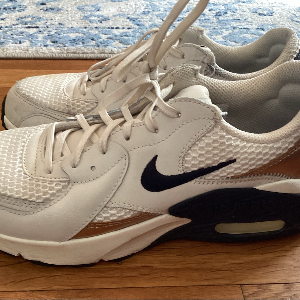 Nike White Sneakers with black Swoosh and gold Accent